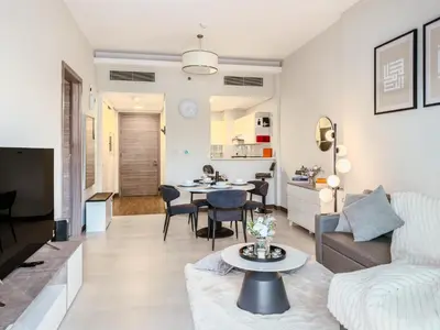 a living room with a couch and a table at Luxury Stunning Burj Khalifa View High Floor Big Balcony Pool&Gym 1BR 80m2 in Dubai