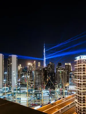 a view of a city skyline at night at Luxury Stunning Burj Khalifa View High Floor Big Balcony Pool&Gym 1BR 80m2 in Dubai