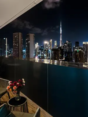 a view of a city skyline at night at Luxury Stunning Burj Khalifa View High Floor Big Balcony Pool&Gym 1BR 80m2 in Dubai