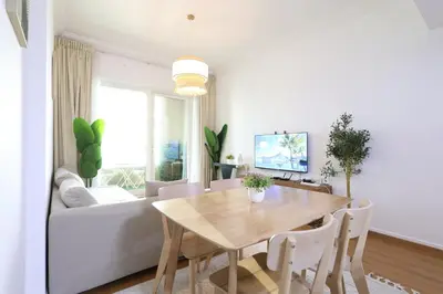 a living room with a table and a couch at Luxury 2BHK In Marina W Rooftop Pool Man 1908 in Dubai
