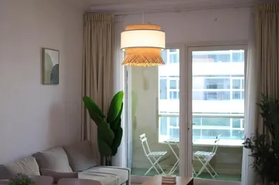 a living room with a couch and a table and a window at Luxury 2BHK In Marina W Rooftop Pool Man 1908 in Dubai