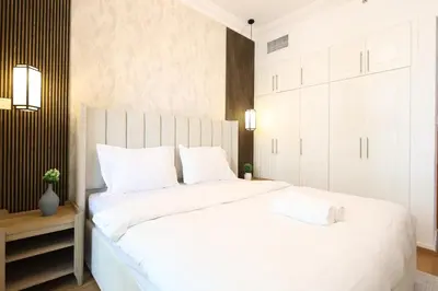 a bedroom with a large white bed with white pillows at Luxury 2BHK In Marina W Rooftop Pool Man 1908 in Dubai