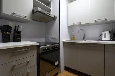a small kitchen with a sink and a stove at Luxury 2BHK In Marina W Rooftop Pool Man 1908 in Dubai
