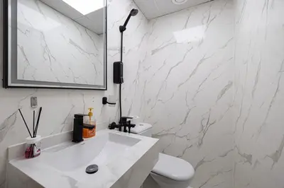 a white bathroom with a toilet and a sink at Lux 3 Bedroom Apt In Dubai Marina Man 2003 in Dubai