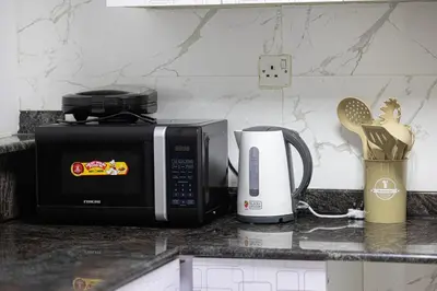 a kitchen counter with a microwave and a coffee maker at Lux 3 Bedroom Apt In Dubai Marina Man 2003 in Dubai