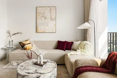 a living room with a couch and a table at New Elegant 1BR with Balcony & Pool in Park Field in Dubai