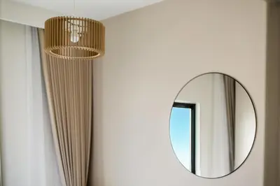 a mirror and a chandelier in a room at New Elegant 1BR with Balcony & Pool in Park Field in Dubai