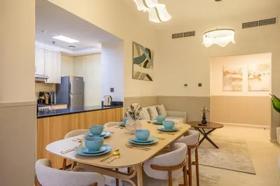 a dining room and kitchen with a table and chairs at Luxury 2BHK in Dubai Marina Escan 2001 in Dubai