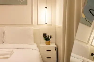 a bedroom with a bed and a plant on a night stand at Luxury 2BHK in Dubai Marina Escan 2001 in Dubai