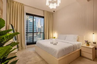 a bedroom with a bed and a large window at Luxury 2BHK in Dubai Marina Escan 2001 in Dubai