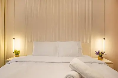 a bedroom with a white bed with two lamps at Luxury 2BHK in Dubai Marina Escan 2001 in Dubai