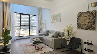 a living room with a couch and a window at Luxury 2BHK in Dubai Marina Escan 402 in Dubai