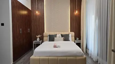 a bedroom with a large bed with two tables at Luxury 2BHK in Dubai Marina Escan 402 in Dubai