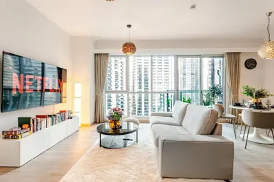 a living room with a couch and a tv at Cozy 1BR Near Burj Khalifa and Dubai Mall in Dubai