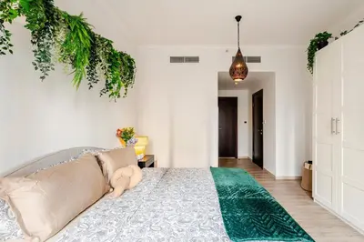 a bedroom with a bed and a pendant light at Cozy 1BR Near Burj Khalifa and Dubai Mall in Dubai