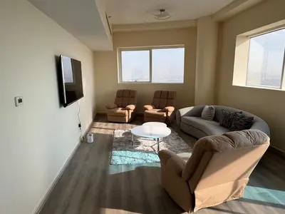 a living room with two couches and a tv at Stunning Furnished 3-Bedroom Apartment in Dubai