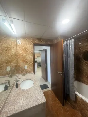 a bathroom with a sink and a shower at Stunning Furnished 3-Bedroom Apartment in Dubai