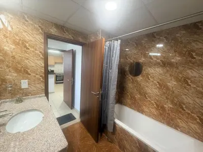 a bathroom with a sink and a shower at Stunning Furnished 3-Bedroom Apartment in Dubai