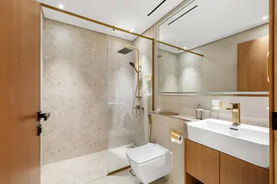 a bathroom with a toilet and a sink and a shower at New! Lovely 1BR with Balcony & Pool in Binghatti Orchid in Dubai
