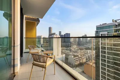 a balcony with chairs and a view of a city at New! Lovely 1BR with Balcony & Pool in Binghatti Orchid in Dubai