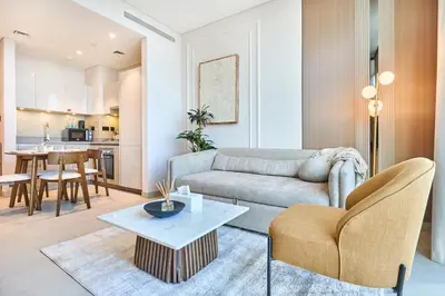 a living room with a couch and a table at STAY BY LATINEM Luxury 1BR plus study Holiday Home W2405 in Dubai