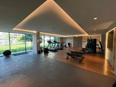 a gym with treadmills and exercise equipment in a room at Daniels 1BR at Viridian by Central Park, City Walk in Dubai