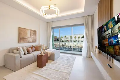 a living room with a couch and a large window at Daniels 1BR at Viridian by Central Park, City Walk in Dubai