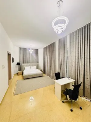 a bedroom with a bed and a desk and a chair at Luxe Villa Rooms in Dubai