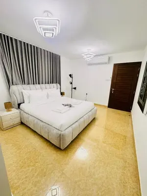 a bedroom with a large white bed in a room at Luxe Villa Rooms in Dubai