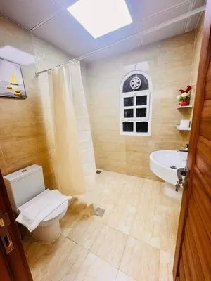 a bathroom with a toilet and a sink at Luxe Villa Rooms in Dubai