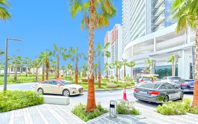 a group of cars parked in a parking lot with palm trees at Studio in Dubai