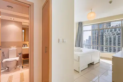 a bathroom with a toilet and a sink with a window at HAVN - 2 bedroom in Marina with Dubai Marina View in Dubai