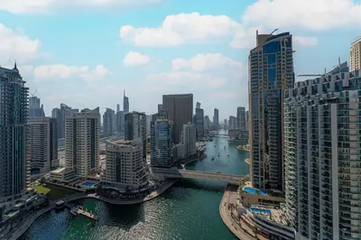 a view of a river in a city with tall buildings at HAVN - 2 bedroom in Marina with Dubai Marina View in Dubai