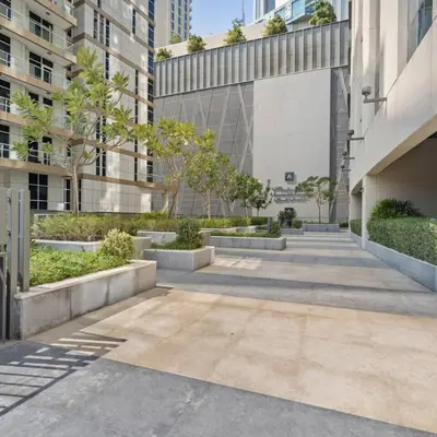 a courtyard in a building with trees and buildings at Dunya Tower in Dubai