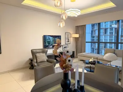 a living room with a couch and a table at Cozy 2BR in Paramount Dubai with Burj Khalifa View in Dubai