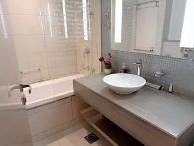 a bathroom with a sink and a bath tub at Cozy 2BR in Paramount Dubai with Burj Khalifa View in Dubai
