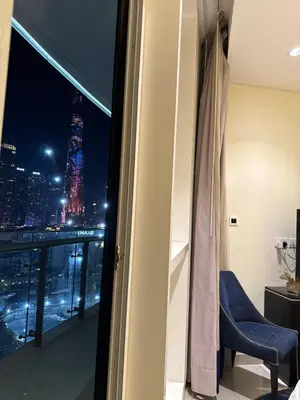a room with a view of a city at night at Spacious 2BR in DAMAC - Burj View in Dubai