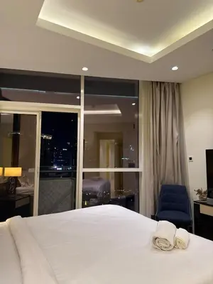 a bedroom with a bed with two towels on it at Spacious 2BR in DAMAC - Burj View in Dubai