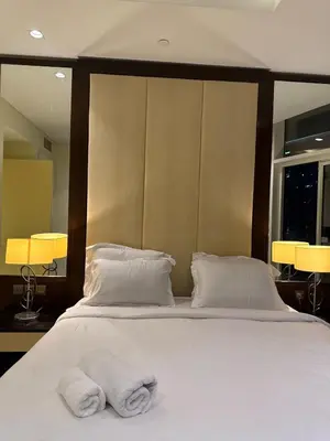 a bedroom with a bed with two towels on it at Spacious 2BR in DAMAC - Burj View in Dubai