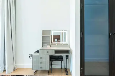 an office with a desk with a mirror and a chair at PVH - Marina Gate 2 - Harmonious 2BR with Sea View in Dubai