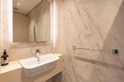 a bathroom with a sink and a mirror at PVH - Marina Gate 2 - Harmonious 2BR with Sea View in Dubai