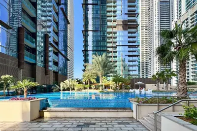 a swimming pool in a city with tall buildings at PVH - Marina Gate 2 - Harmonious 2BR with Sea View in Dubai