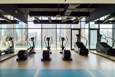 a gym with cardio machines in a room with a view at PVH - Marina Gate 2 - Harmonious 2BR with Sea View in Dubai