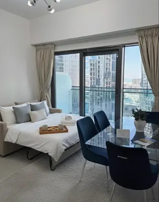 a bedroom with a bed and a glass table at 1BR Canal Views Large Balcony Spacious BusinessBay in Dubai