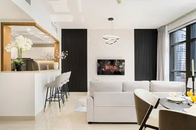 a living room with a white couch and a table at New 1BR Burj View Infinity Pool 5min Dubai mall in Dubai