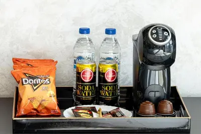 a tray with two bottles of soda and a blender at New 1BR Burj View Infinity Pool 5min Dubai mall in Dubai