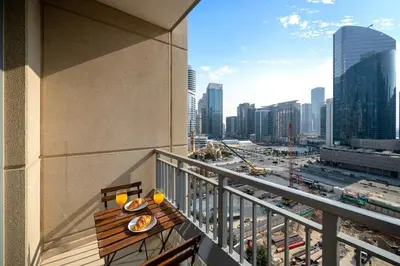 a balcony with a table with plates of food on it at New 1BR Burj View Infinity Pool 5min Dubai mall in Dubai