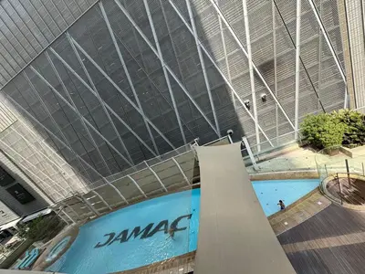 a large swimming pool in a building at Damac Maison mall street in Dubai