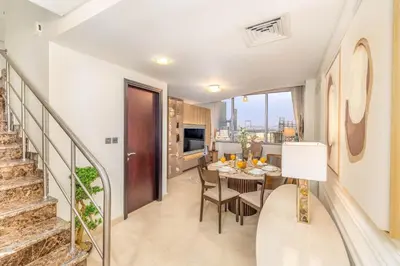 a dining room and kitchen with a table and chairs at Sky Gardens By Luxe Living Collection - Duplex 2BR - DIFC in Dubai