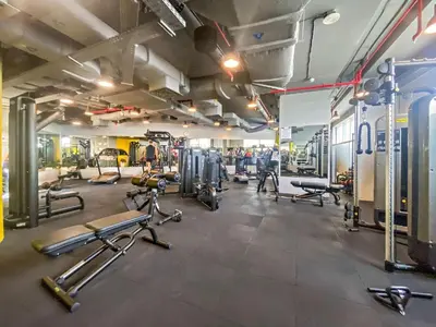 a gym with several treadmills and cardio machines at Sky Gardens By Luxe Living Collection - Duplex 2BR - DIFC in Dubai